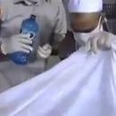 القذافي وابنه المعتصم #(بالفيديو) غسل وتكفين