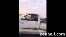 لشخص يسحب كلب بالسيارة على الاسفلت